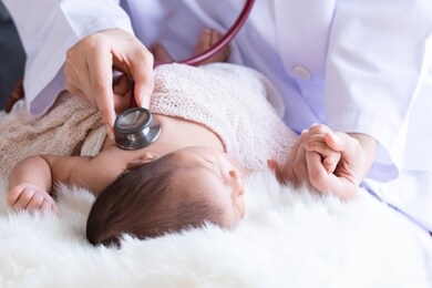 asian newborn baby get sick sleeping during examine by pediatrician doctor hand hold stethoscope, doctor monitoring heart pulse rate adorable newborn crying on bed in clinic, baby health care concept 