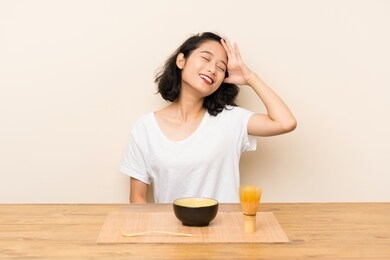 young asian girl with tea matcha has realized something and intending the solution