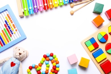 colorful kids toys on white background. top view, flat lay.
