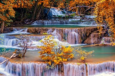 hot springs onsen natural bath surrounded by red-yellow leaves. in fall leaves fall .waterfall among many foliage, in the fall leaves leaf color change.soft focus.
huai mae kamin waterfall.