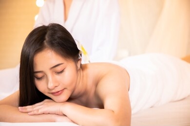 asian beautiful, young and healthy woman in spa salon. massage treatment spa room  . traditional medicine and healing concept.