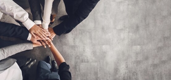 teambuilding concept. business team putting their hands together, top view, free space, panorama