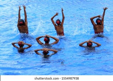 yogyakarta, indonesia, 07/28/2016. beautiful synchronize swimming athletes do training sessions in the pool.