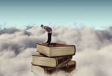 kid standing on stack of books above clouds. 