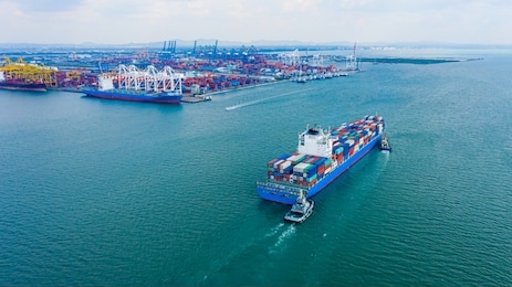 aerial view cargo ship of business logistic transportation sea freight,cargo ship, cargo container in factory harbor at industrial estate for import export around in the world, trade port / shipping 
