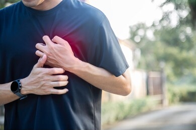 exhausted runner suffering heart, maybe he got overtrain or heart attack