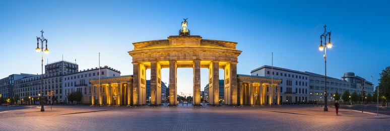 pretty night time illuminations of the brandenburg gate (1788) inspired by greek architecture, built as a symbol of peace and nationalism, now an emblem of reunification.