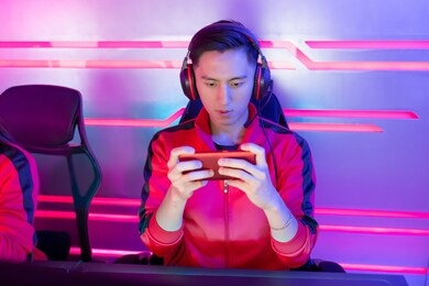 young asian teenage cyber sport gamer play mobile game by smartphone on esport tournament
