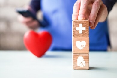 doctor hand arranging wood block stacking with healthcare icons, insurance for your health.