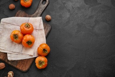 ripe persimmons on dark background