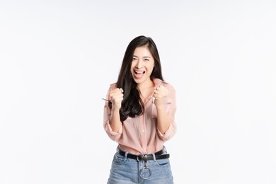 beautiful black long hair young asian woman, girl feeling very happy amazed excited and surprised, studio light portrait shot isolated on white background. in a summer t-shirt short jeans. copy space 