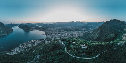 aerial panorama drone view of lugano lake, monte bre, salvatore and lugano city in switzerland