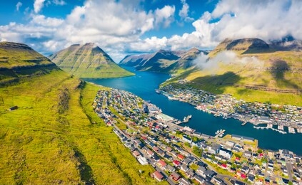 view from flying drone. captivating summer cityscape of klaksvik town. aerial morning scene of bordoy island, faroe, denmark, europe. traveling concept background.