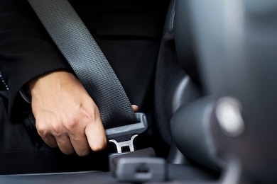 close up of people business man hand fastening seat safety belt in car for safety before driving on the road. concept transport travel. soft focus.