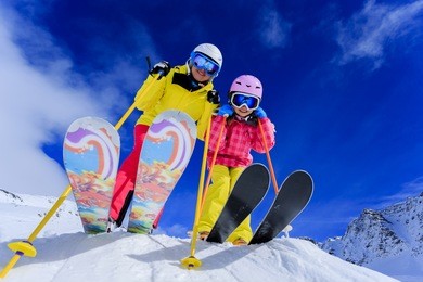 ski, skiers, sun and winter fun - skiers enjoying ski vacation