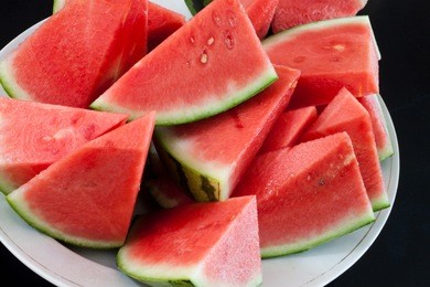 pieces of watermelon served on a white plate