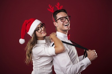 christmas portrait of confident nerdy man with his girlfriend