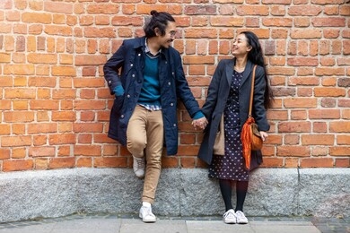 happy young couple, walking through the old city, warsaw, poland
