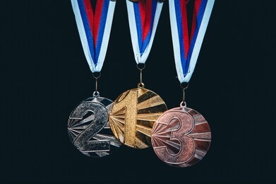 gold, silver and bronze medal, black background