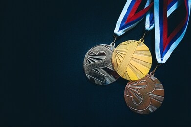 gold, silver and bronze medal, black background