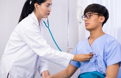 asian doctor checking heartbeat of sick patient in bed. sick patient admit to hospital for medical treatment. medication & hospital fee is paid by health care insurance. doctor and patient concept.