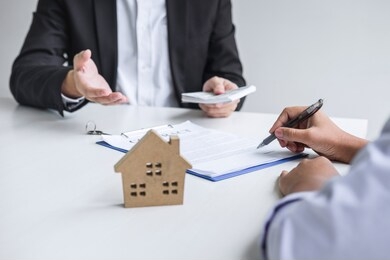 estate agent broker receive money from client after signing agreement contract real estate with approved mortgage application form, buying or concerning mortgage loan offer for and house insurance.