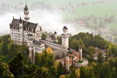 neuschwanstein castle shrouded in mist in the bavarian alps of germany.