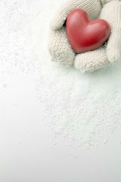 female hands in mittens with red heart, close-up