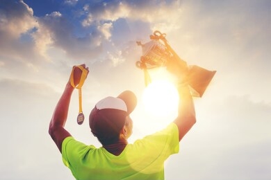 silhouette marathon runner hand holding finisher trophy award and 2020 finisher medal celebrate his successful. winning finisher concept