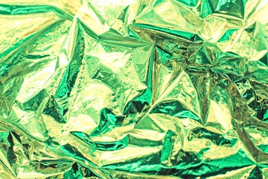 bright christmas and new year gold and mint background. shiny green mint foil texture.