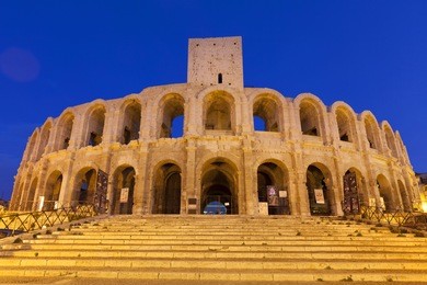 les arÃ?Â¨nes d'arles is an old roman amphitheatre situated in arles, provence-alpes-cote-d'azur, france, europe. illuminated at night.
