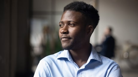head shot close up young thoughtful african american businessman entrepreneur looking away. pensive mixed race confident international company employee manager thinking of problem solution at office.