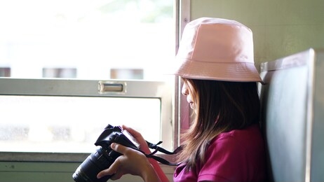 asian woman tourists taking pictures on the train            