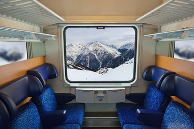 interior of train and mountains in window - travel background