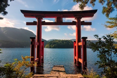 the torii gate which stands on the shore of lake ashi, near mount fuji in japan.