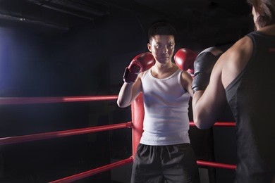 two male boxers getting ready to box in the boxing ring 