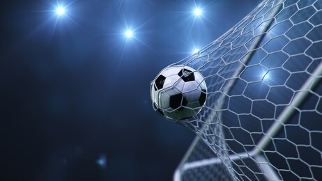 soccer ball flew into the goal. soccer ball bends the net, against the background of flashes of light. soccer ball in goal net on blue background. a moment of delight. 3d illustration
