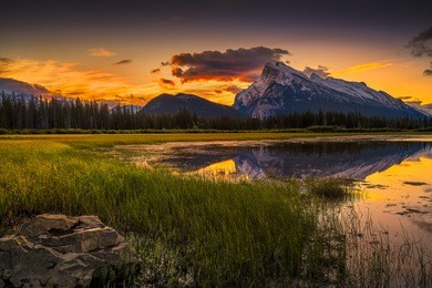 golden early fall sunrise over the canadian rockies and vermilion lakes on the outskirts of banff, canada
