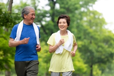 senior couple exercising in the park