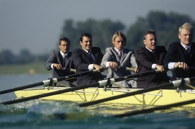 team of rowers in business suits