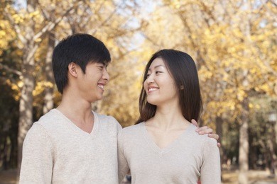 young couple in park in autumn
