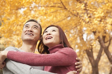 mature couple embracing in park