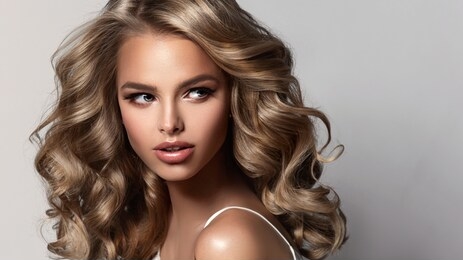 beauty brunette girl with long  and   shiny wavy  hair .  beautiful   woman model with curly hairstyle . perm, trichology and care