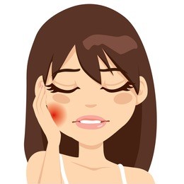 young woman suffering toothache pain pressing her cheek with a painful expression
