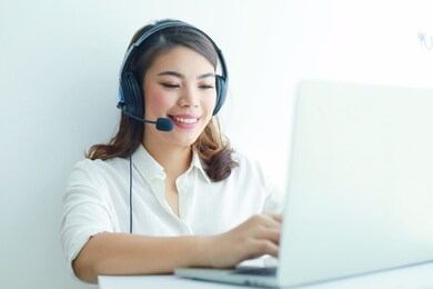 cheerful customer services operator asian woman working in office.