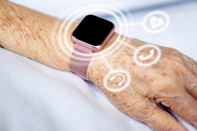 asian senior or elderly old lady woman wear modern smart watch put your hand on the blue cloth and she using smart watch for omnichannel. healthcare, medical, omnichannel and technology concept.