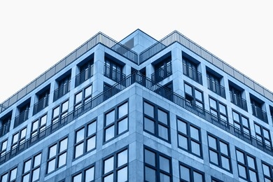 a residential building in trendy classic blue color with cut out sky with white isolated background.