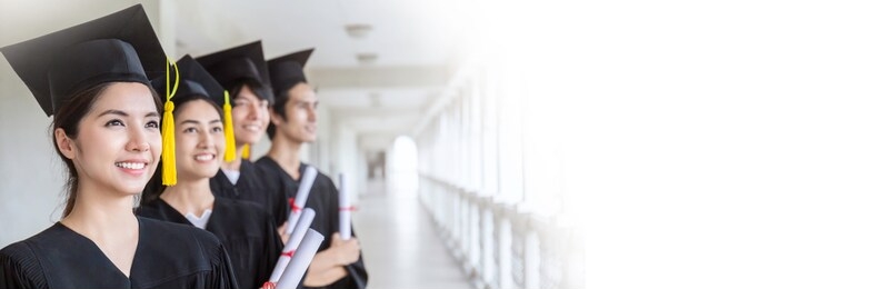 portrait of young happy asian man and woman graduates standing in line in front of university building on graduation day. multicultural people with successful education panoramic banner
