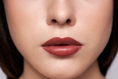 perfect red lips makeup. close up macro photo with a beautiful female mouth. full lips full. large detail of the face. perfect clear skin, light fresh lip makeup. 