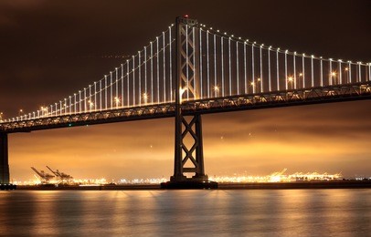 new lights illuminate the bay bridge connecting san francisco and oakland over san francisco bay in california.